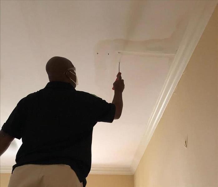 Marco cutting into wet ceiling 