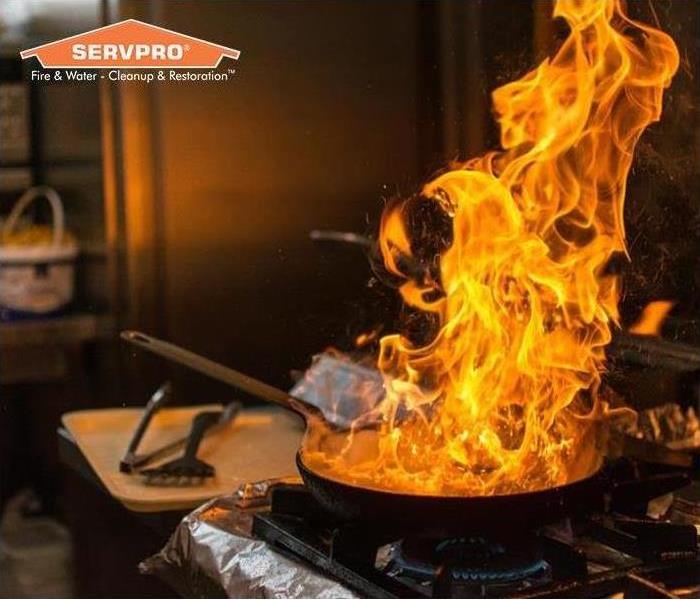 Pot on fire in kitchen with SERVPRO logo